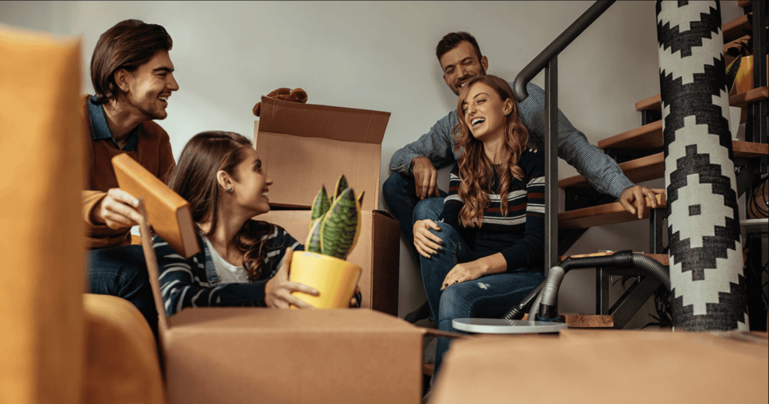 four-people-unpacking-boxes-from-moving.png