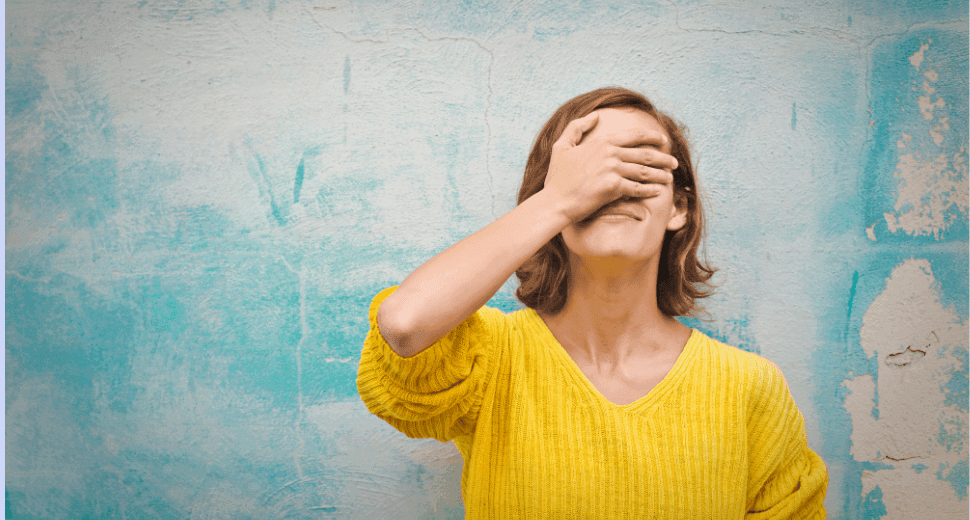 girl-covering-eyes-in-front-of-wall.png