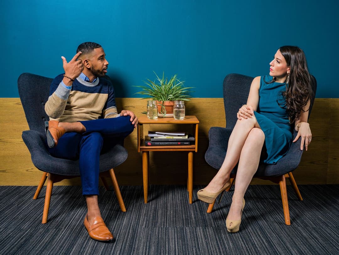 man-and-woman-sitting-in-chairs-talking.jpg