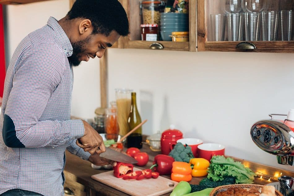 man-cooking-at-home-cutting-veggies.jpg