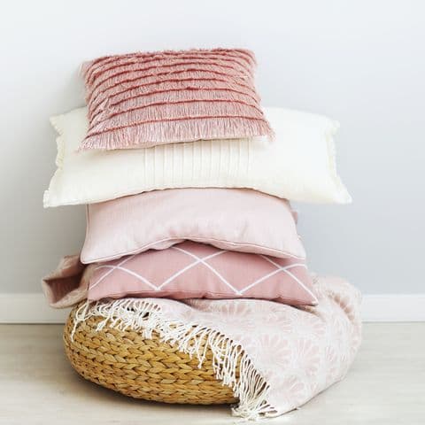 pink-and-white-pillows-against-wall.jpg