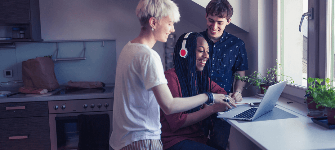 three-young-adults-listening-to-music-on-laptop.png