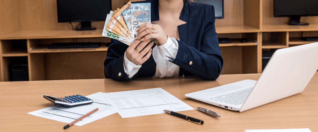 woman-counting-money-at-table.png
